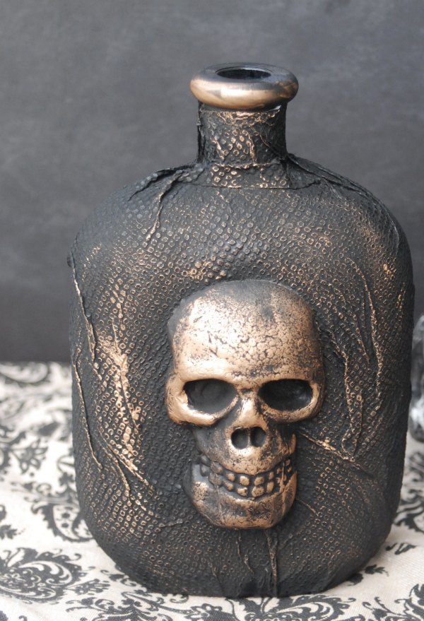 Transform a plain glass bottle into a creepy skull bottle decoration. You will never guess what you use to make this!