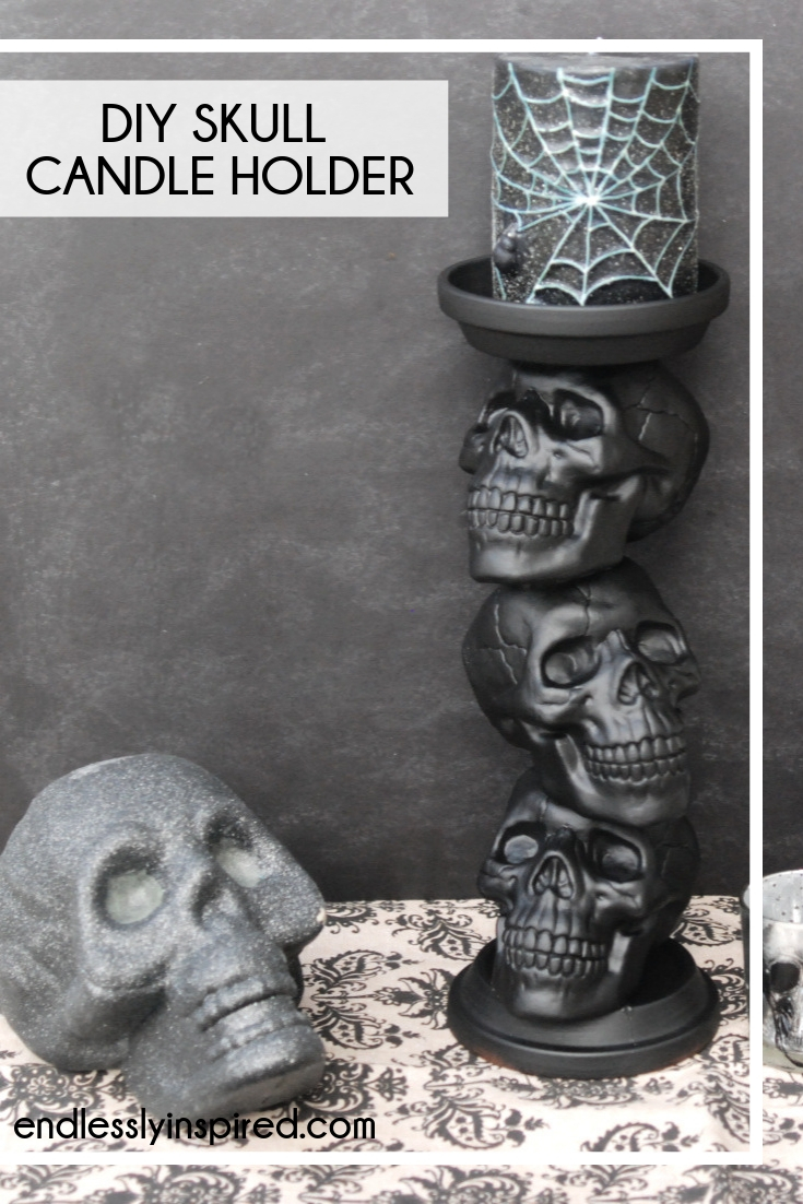 Black glitter skull and black candle holder with three skulls and a black glittery spiderweb candle