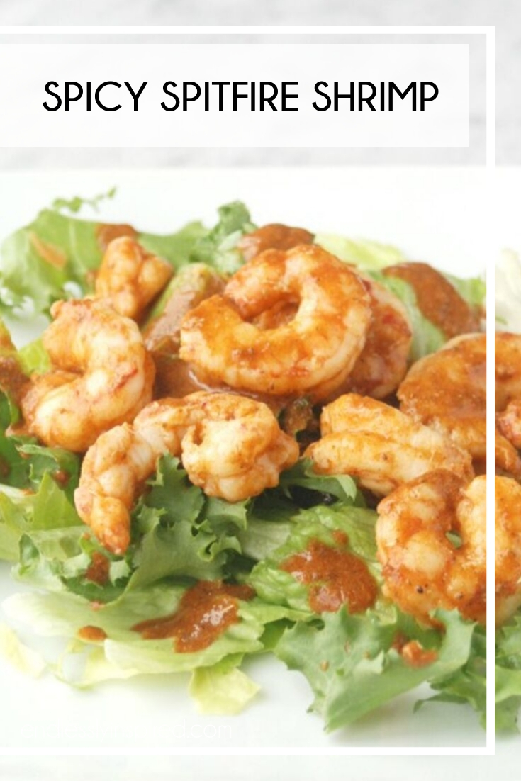 Spicy shrimp on a bed of lettuce on a white plate