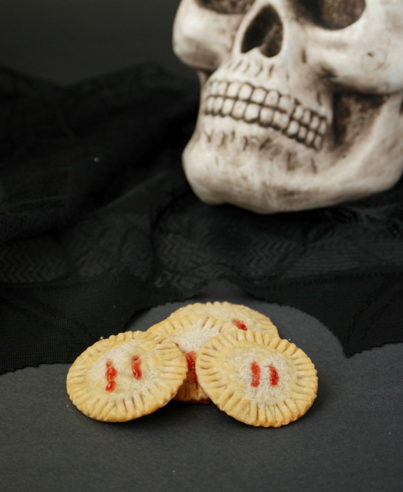 Strawberry jam oozes from "bite marks" in these fun and easy Vampire Pie Bites!