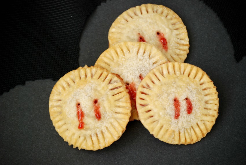 Strawberry jam oozes from "bite marks" in these fun and easy Vampire Pie Bites!