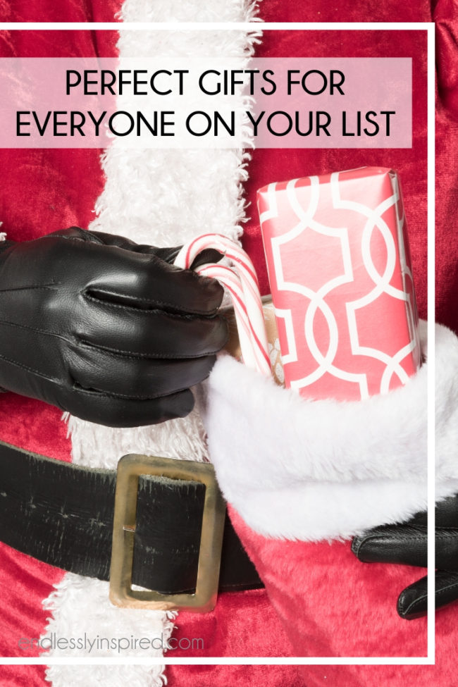 Santa holding a stocking that contains a gift and candy canes.